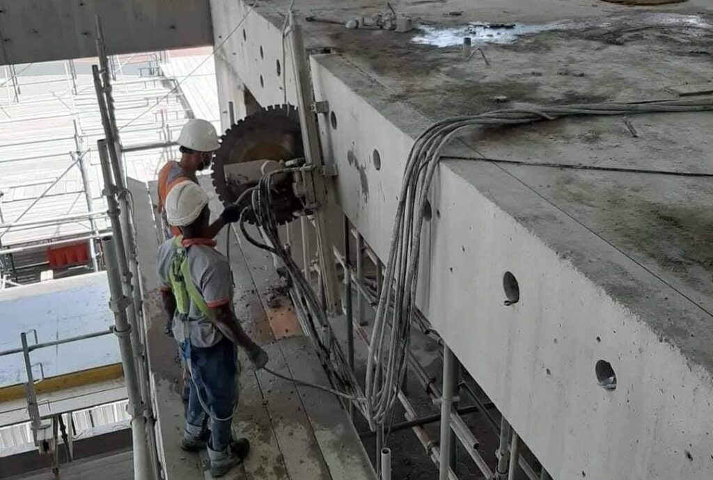 Core cutting machine drilling concrete wall at construction site in United Arab Emirates