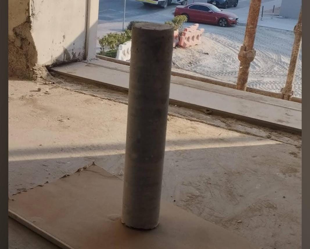 Concrete slab coring machine drilling precise hole in floor slab at construction site in United Arab Emirates