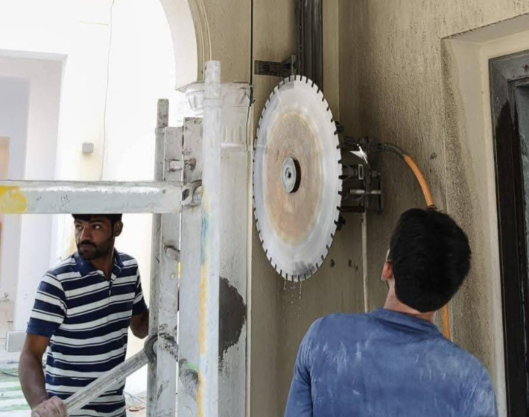 Concrete wall cutting machine creating precise opening in wall at construction site in United Arab Emirates